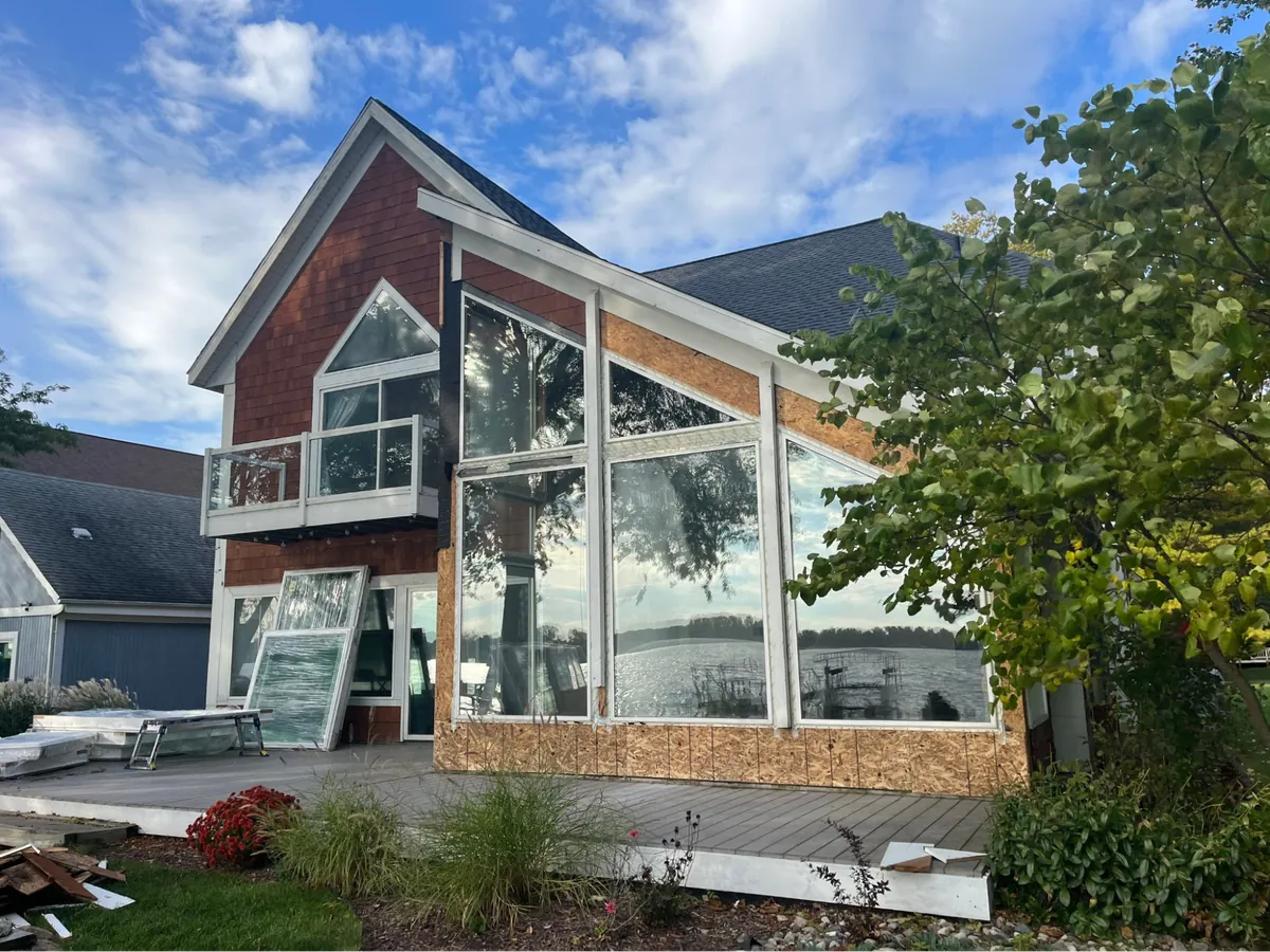 Dramatic custom multi-tier geometric trapezoid window wall on lakefront home remodel